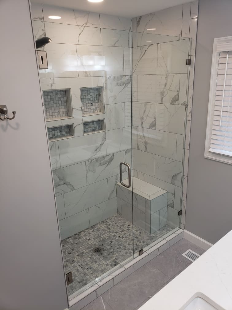 Marble-tile shower with built-in niche shelving