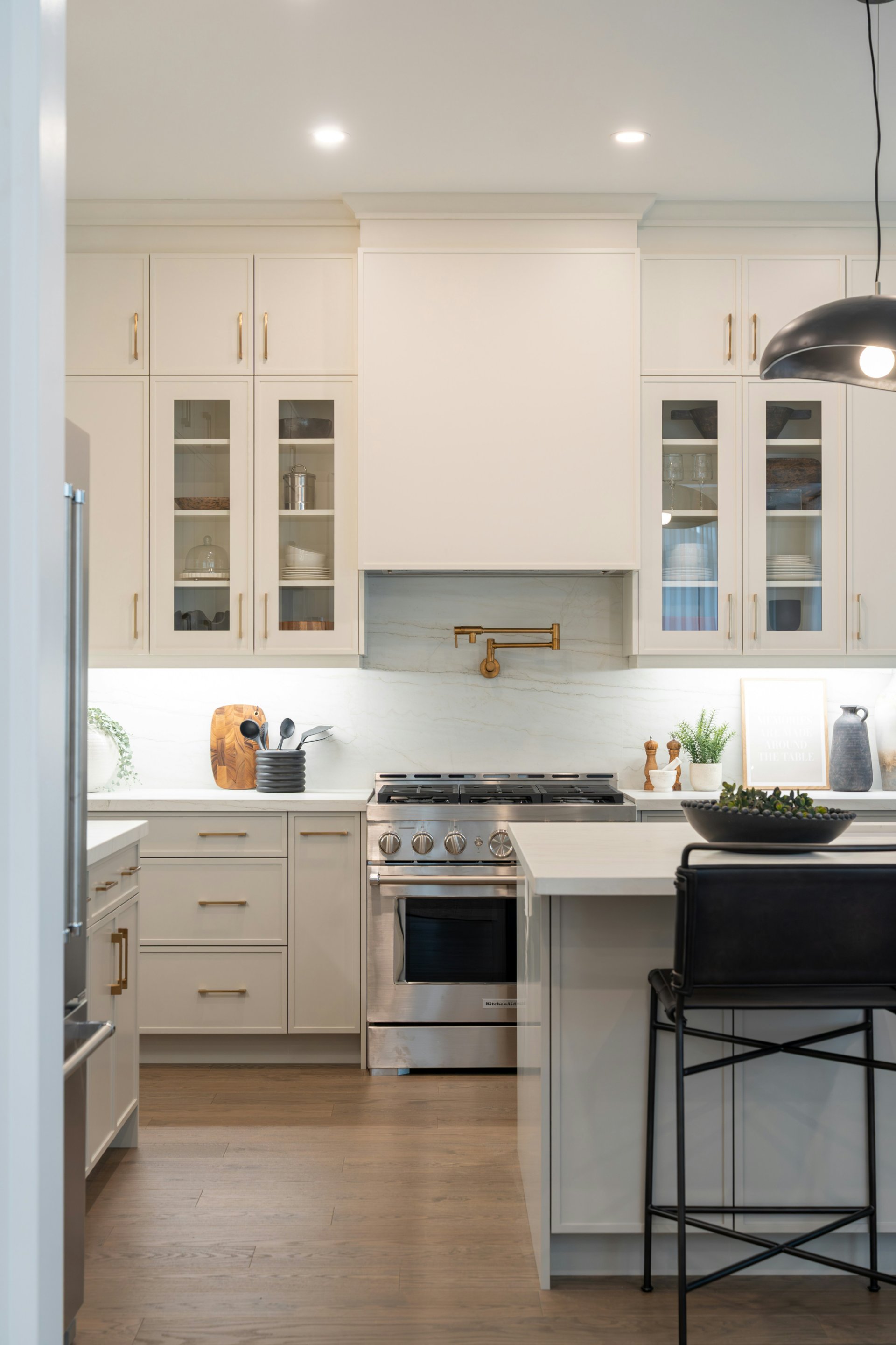 Finished kitchen with new cabinetry, island, and hardwood floors