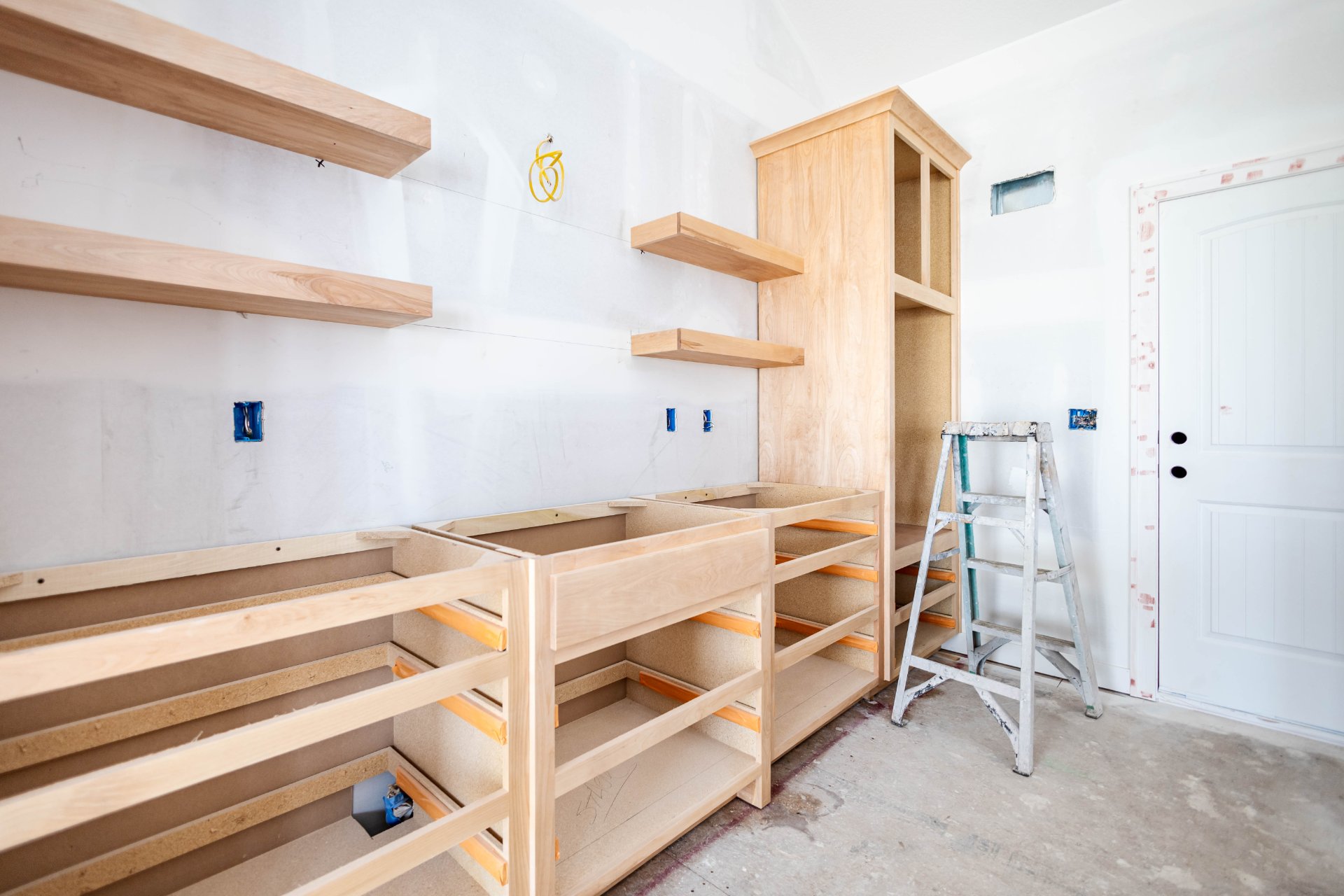 Unfinished cabinet boxes and shelving during a kitchen build