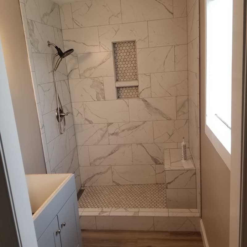 Marble shower with bench seat and recessed niche